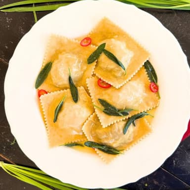 River fish ravioli with guanciale butter and sage.